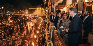 Kandy Esala Perahera nighttime procession with traditional Kandyan dancers, drummers, torchbearers and ceremonial elephants in Kandy, Sri Lanka.