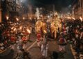 Kandy Esala Perahera nighttime procession with traditional Kandyan dancers, drummers, torchbearers and ceremonial elephants in Kandy, Sri Lanka.