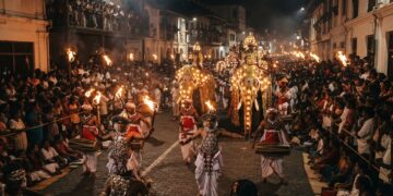 Kandy Esala Perahera nighttime procession with traditional Kandyan dancers, drummers, torchbearers and ceremonial elephants in Kandy, Sri Lanka.