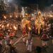 Kandy Esala Perahera nighttime procession with traditional Kandyan dancers, drummers, torchbearers and ceremonial elephants in Kandy, Sri Lanka.